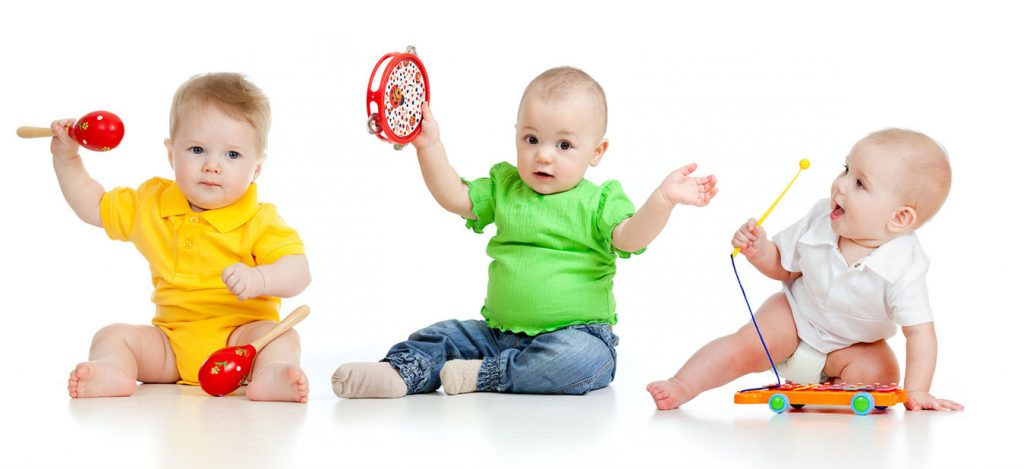 Children playing with musical toys. Isolated on white background