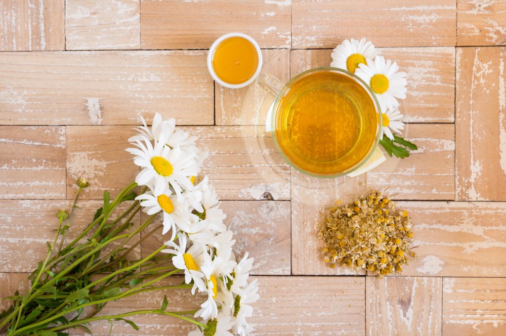 chamomile tea with lemon and honey on the wood background