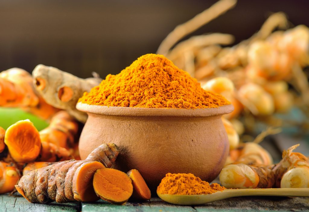 turmeric roots on wooden table